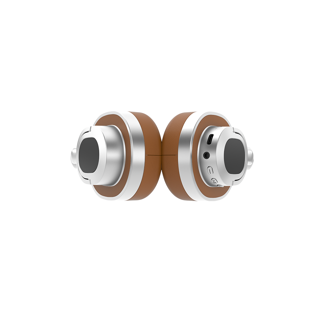 Groove Studio headphones in Brown, earcups folded flat showing the USB-C charging port, 3.5mm AUX jack, power button and playback controls