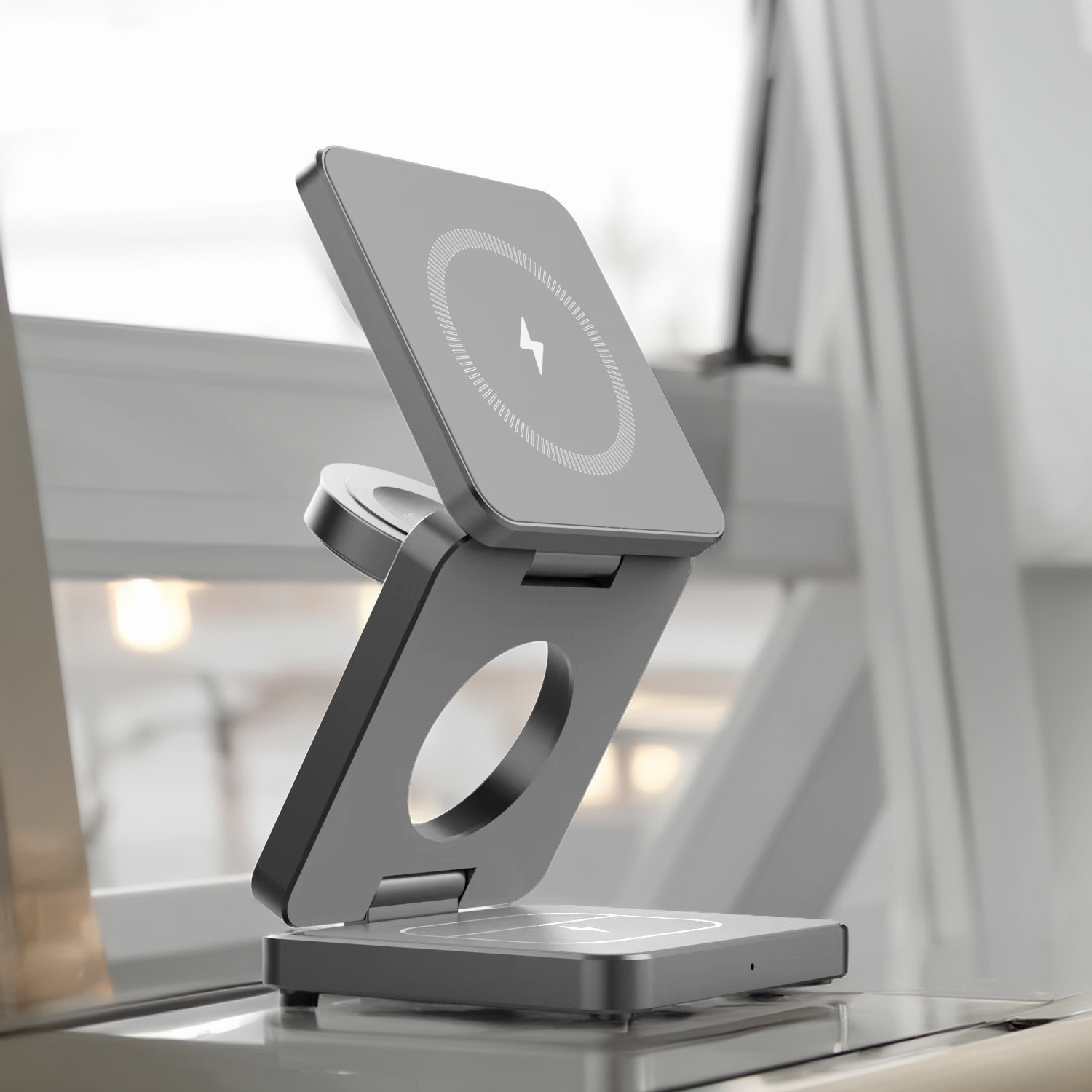 Multi-device Travel charging stand on a desk with blurred office background